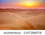 Sun rising over dunes of Dubai Desert Conservation Reserve, UAE