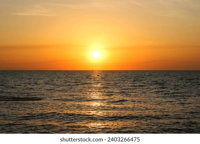 Sun rising over the sea. Orange sunrise. Sea surface
