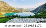 Sun rising over teal Colchuck lake with mountain reflections