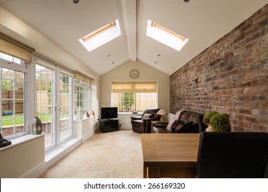 Sun Room / Modern Sunroom or conservatory extending into the garden with a featured brick wall - Shutterstock ID 266169320