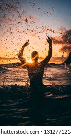 sun set in sea with a man who was bathing in the river - Shutterstock ID 1312771214