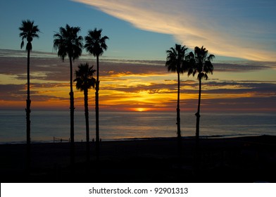 The Sun Sets Behind A Bank Of Clouds Over The Pacific Ocean As Viewed From The Hills Of Malibu, California.