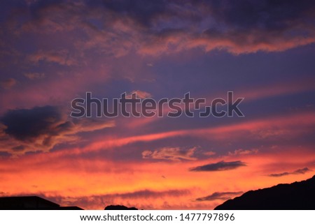 The sun sets behind the mountains