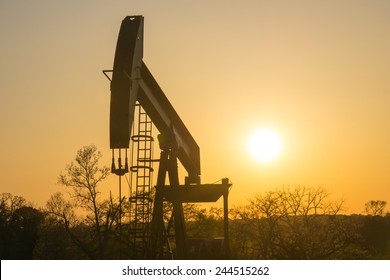 The Sun Sets Behind A Texas Oil Well.