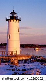 Sun sets by Portsmouth Harbor lighthouse, or Fort Constitution light, as it guides fishermen during winter into Portsmouth Harbor. The historic beacon is one of two seacoast lights in New Hampshire.
