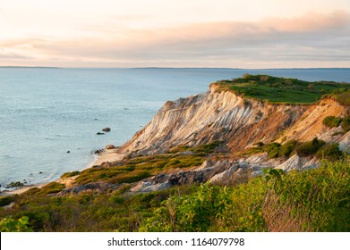 Sun sets illunimating sandy cliffs of Moshup Beach in Aquinnah, on Martha’s Vineyard island, in Massachusetts. It is a favorite attraction for tourists looking for a spiritual connection.