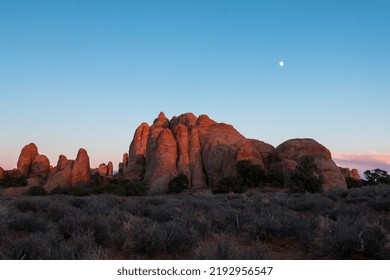 As the sun sets, the moon rises over the beautiful and amazing landscapes that make up Arches National Park.
