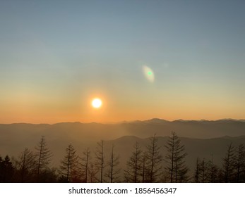 The sun sets in the mountains.