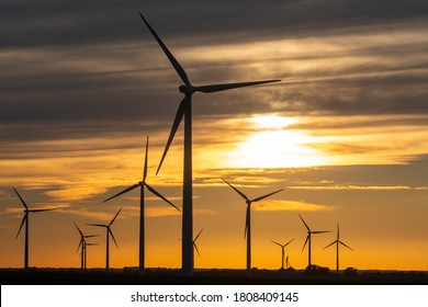 The sun sets on a field of wind turbines at a wind farm in Indiana, United States. - Shutterstock ID 1808409145