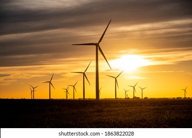 The sun sets on a field of wind turbines at a wind farm in Indiana, United States. - Shutterstock ID 1863822028