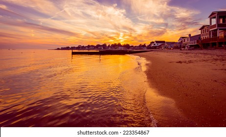 The sun sets on the final days of summer over a beach on Long Island Sound in Connecticut.