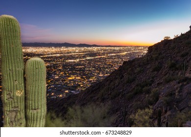 The sun sets on Phoenix on a spring night at Camelback Peak.