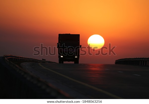 The sun\
sets over cars driving along a highway in Almaty region,\
Kazakhstan, November 05, 2020.  Pavel\
Mikheev