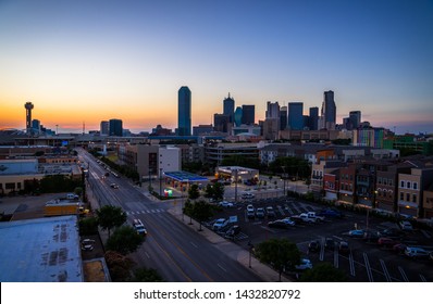 As The Sun Sets Over Dallas Texas USA Skyline Cityscape Blue Hour Sunset City Lights Glowing At Night Long Street Perspective