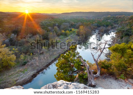 The sun sets over the Greenbelt in Austin, Texas