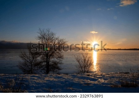 The sun sets over Lake Ontario during a wintry evening at Sam Smith Park in Toronto.