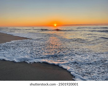sun sets over the ocean 