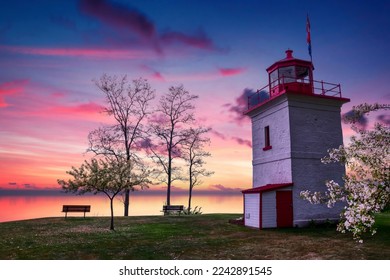 The sun sets over the still waters of Lake Huron as seen from the historic Goderich Lighthouse. - Powered by Shutterstock