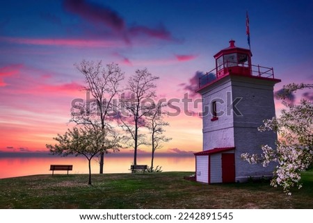 The sun sets over the still waters of Lake Huron as seen from the historic Goderich Lighthouse.