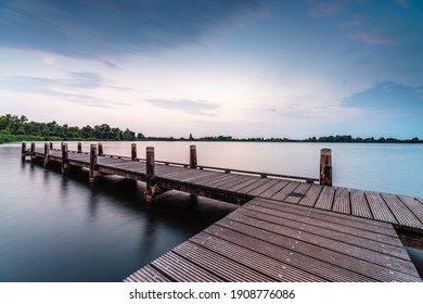 
As the sun sets over the Vlietlanden, a wooden pier or jetty invites you to enjoy the tranquil beauty of nature in Voorschoten - Powered by Shutterstock