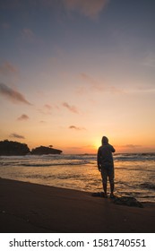 the sun sets with silhouettes