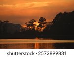 The sun sets in the trees on the western shore of Assawoman Bay near the towns of Ocean City, Maryland and Fenwick Island, Delaware.