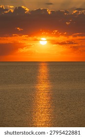 Sun setting behind clouds over the Adriatic Sea with radiant sunbeams, Italy, Roseto degli Abruzzi, 28 May 2026