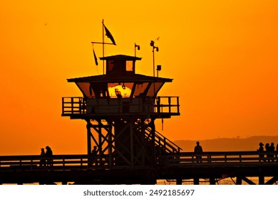 Sun Setting behind a guard tower on San Clemente Pier.  - Powered by Shutterstock