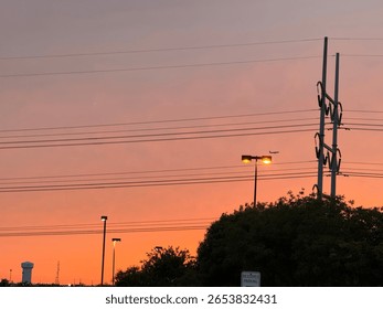 sun setting behind power lines 