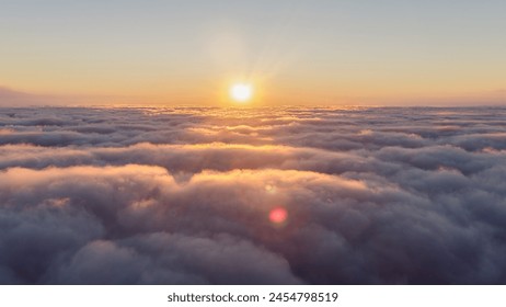 The sun is setting, casting a red glow over the clouds in the sky, creating a beautiful afterglow during dusk