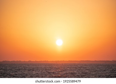 The sun setting into the sea.