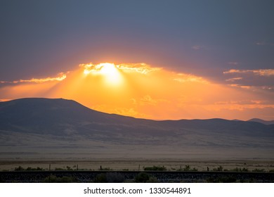 Sun setting in mountains