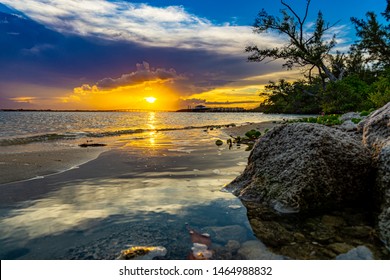 sun setting on the beach reflection