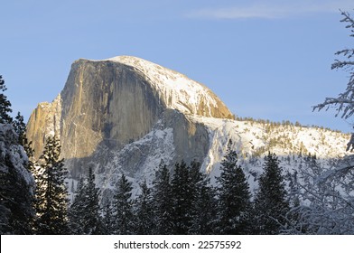 Sun setting on Half Dome in Yosemite National Park in winter