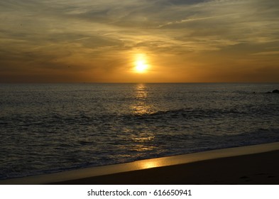 sun setting over a beach