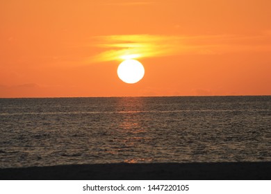 The sun setting over the beautiful blue ocean