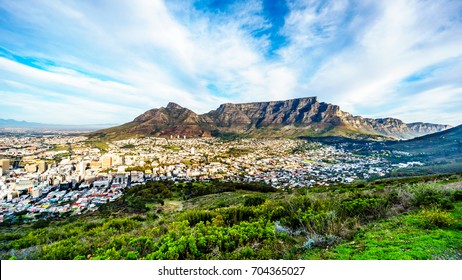Sun setting over Cape Town, Table Mountain, Devils Peak, Lions Head and the Twelve Apostles. Viewed from the road to Signal Hill at Cape Town, South Africa