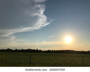 Sun setting over field