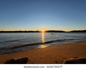 The sun setting over the Highlands across the bay. 