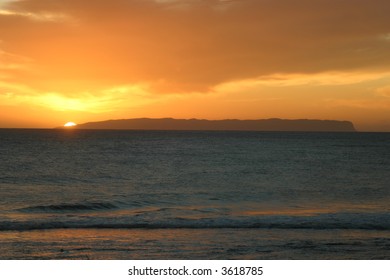 Sun Setting Over The Island Of Ni'ihau, Hawaii.