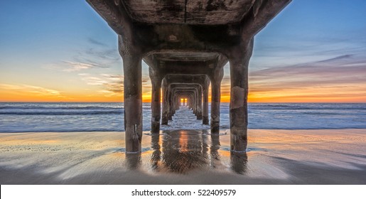 sun setting over manhattan beach,shot under its iconic pier,manhattan beach,california,2015