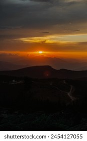 Sun setting over mountain range