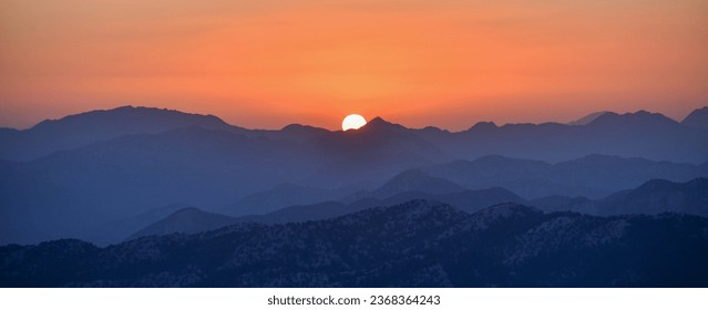 The sun setting over the mountains