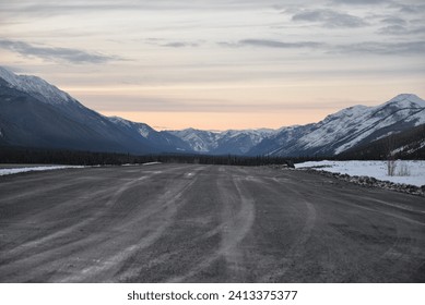 Sun Setting Over the Northern Rocky Mountains and Isolated Alaska Highway in Yukon Territory Canada
