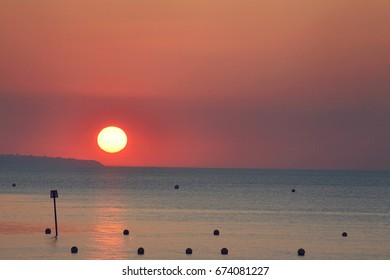 Sun setting over ocean