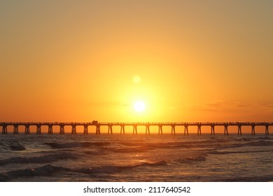 sun setting over the pier