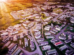Sun Setting Over The Sea And Caravan And Camping Park, Static Home Aerial View. Porthmadog Holiday Park Taken From The Air By A Drone