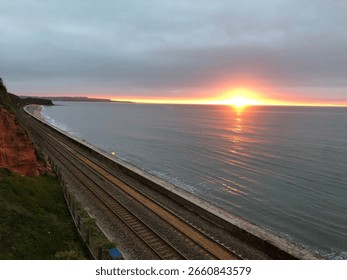 Sun setting over sea Train Track Coastline