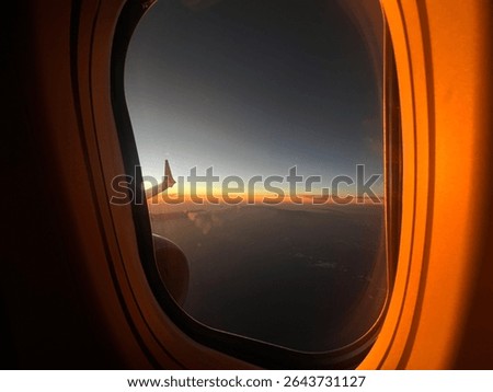 Sun setting plane window view