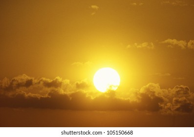 Sun Setting Through Clouds